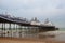 Famous Eastbourne Pier and beach in cloudy day. East Sussex, Eng