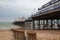 Famous Eastbourne Pier and beach in cloudy day. East Sussex, Eng