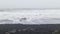 The famous endless black beach on Iceland in strong winds with powerful surf