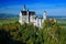 Famous fairy tale Neuschwanstein Castle in Bavaria, Germany, afternoon with blue sky
