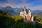 Famous fairy tale Neuschwanstein Castle in Bavaria, Germany, late afternoon with blue sky with white clouds