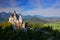 Famous fairy tale Neuschwanstein Castle in Bavaria, Germany, late afternoon with blue sky with white clouds