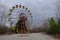 The famous Ferris wheel in an abandoned amusement park in Pripyat. Cloudy weather in the Chernobyl exclusion zone