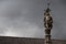 Famous fountain statue from `Largo do Paco`, with a cloudy gray sky background in Braga.