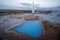 The famous geysir/Strokur with high burst, in Haukadalur valley near Reykjavik in Iceland during blue hour with no people around.