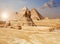 Famous Giza Sphinx and the Pyramids on the background, Egyptian desert