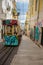 Famous hill tram with graffiti in Lisbon, Portugal. Electric elevator train. Portuguese transport concept. Street art graffiti.