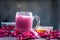 Famous Indian & Asian Summer and Ramadan drink i.e. Gulab shake or Rose falooda in a glass on wooden surface.