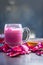 Famous Indian & Asian Summer and Ramadan drink i.e. Gulab shake or Rose falooda in a glass on wooden surface.