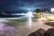 Famous Ipanema Beach At Night With Beautiful Lights And Slow Water Waves Over Rocks