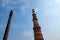 Famous Iron Pillar with the Qutub Minar minaret columb in New Delhi, India, located In the courtyard of the Quwwatuâ€™l-Islam