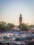 Famous Jemaa el Fna square near the famous minaret of the Koutoubia mosque in Marrakech, Morocco