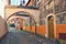 Famous Josef Vachala street. Colorful narrow street with archway and black and white pictures in the wall. Litomysl,Czech Republic