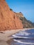 The famous Jurassic Coast red cliffs at Sidmouth, Devon, England. Looking East from Sidmouth Beach to Salcombe Hill