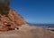 The famous Jurassic Coast red cliffs at Sidmouth, Devon, England. Looking East from Sidmouth Beach with warning of