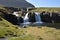 Famous kirkjufell mountain with the kirkjufell falls waterfalls in front in Iceland