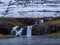 Famous Kirkjufellsfoss waterfall and the snow mountain, Iceland
