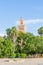 Famous Koutoubia or Kutubiyya Mosque with green palm garden in foreground, Marrakesh, Morocco, North Africa