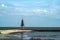 Famous Kugelbake day beacon in Cuxhaven against a blue cloudy sky
