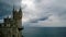 Famous landmark South of the Crimea - the Swallow`s nest castle in cloudy weather.