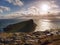 Famous look at Lighthouse on the cliff of Neist Point, rocky coast on the Isle of Skye