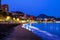 Famous Malagueta beach in Malaga, Spain at night. Coastline and motion blurred waves at sunset