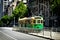 Famous Melbourne city cycle trams with tour groups at Australia
