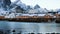 Famous multicolored wooden fishing houses rorbu on a sea shore