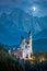 Famous Neuschwanstein Castle at night with moon and illumination