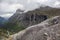 Famous norwegian mountains road Trollstigen. Top view of valley from big grey rock