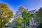 Famous Okayama Crow Castle or Ujo Castle in Okayama City on the Asahi River in Japan. With Maple Tree On Foreground