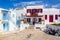 Famous old town narrow street with white houses. Mykonos island, Greece