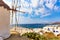 Famous old windmill in Chora with city view. Summer sunny day. Mykonos island, Greece