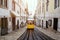 Famous old yellow tram on street of Lisbon, Lisboa.