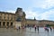 Famous Paris Louvre. People in main courtyard Cour Napoleon with Louvre Museum with Louvre Pyramid