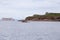 The famous PercÃ© rock and the Bonaventure Island surrounded by cormorants, seagulls and grey seals