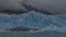 The famous Perito Moreno glacier. A blue cracked ice wall and broken icebergs