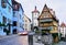 Famous Plonlein Gingerbread House in Rothenburg with blurred speeding car