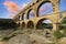 Famous Pont du Gard at sunset, old roman aqueduct in France