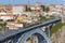 Famous Porto bridge Ponte Luis with yellow train top view. Metro bridge with train. Urban transportation concept.