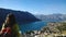 Famous postcard view of the Bay of Kotor in Montenegro. Tourist admires the view, shot from the back