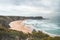 Famous Praia dos Machados beach in Odemira, western Portugal. The rocks surrounding the moon-shaped sandy beach with large waves