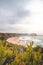 Famous Praia dos Machados beach in Odemira, western Portugal. The rocks surrounding the moon-shaped sandy beach with large waves