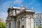 Famous Puerta de Alcala on a beautiful sunny day in Madrid City. Inscription on the pediment: King Carlos III year 1778