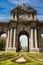 Famous Puerta de Alcala on a beautiful sunny day in Madrid City. Inscription on the pediment: King Carlos III year 1778