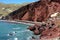 The famous red beach with sheer black and red cliffs and red sand on the island of Santorini, Akrotiri village