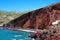 The famous red beach with sheer black and red cliffs and red sand on the island of Santorini, Akrotiri village