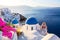 Famous Santorini iconic view. Blue domes and traditional white houses with bougainvillea flowers. Oia village, Santorini island,