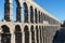 Famous Segovia aqueduct in the center of the citadel, unesco world heritage in spain. Rome architecture with medieval arch and