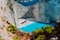 Famous shipwreck on Navagio beach with turquoise blue sea water surrounded by huge white cliffs. Famous landmark
